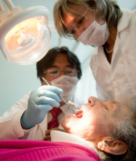 Dentist working on an elderly patient with cognitive decline.
